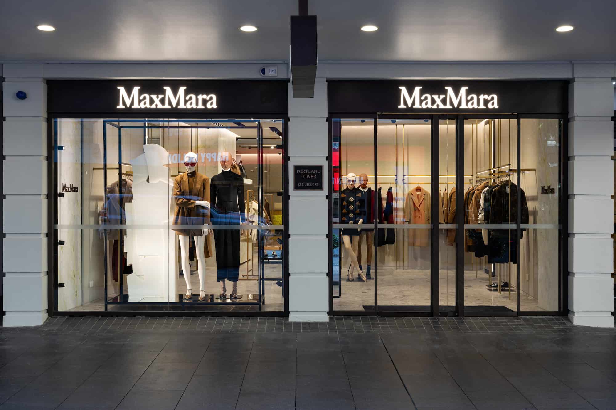 Image of Max Mara storefront with mannequins and clothes featured in the window